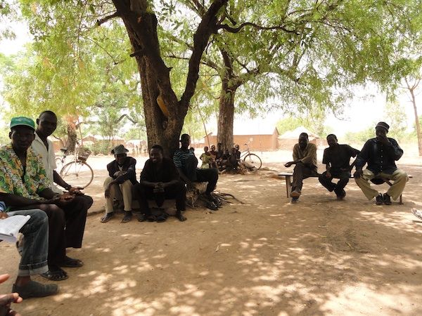 People gathered under trees in Togo